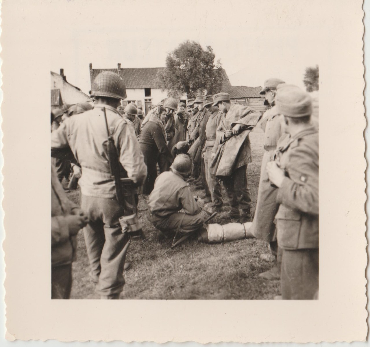 In this village a few kilometers south of Mons, German prisoners are interrogated by GIs of the 3rd armored.